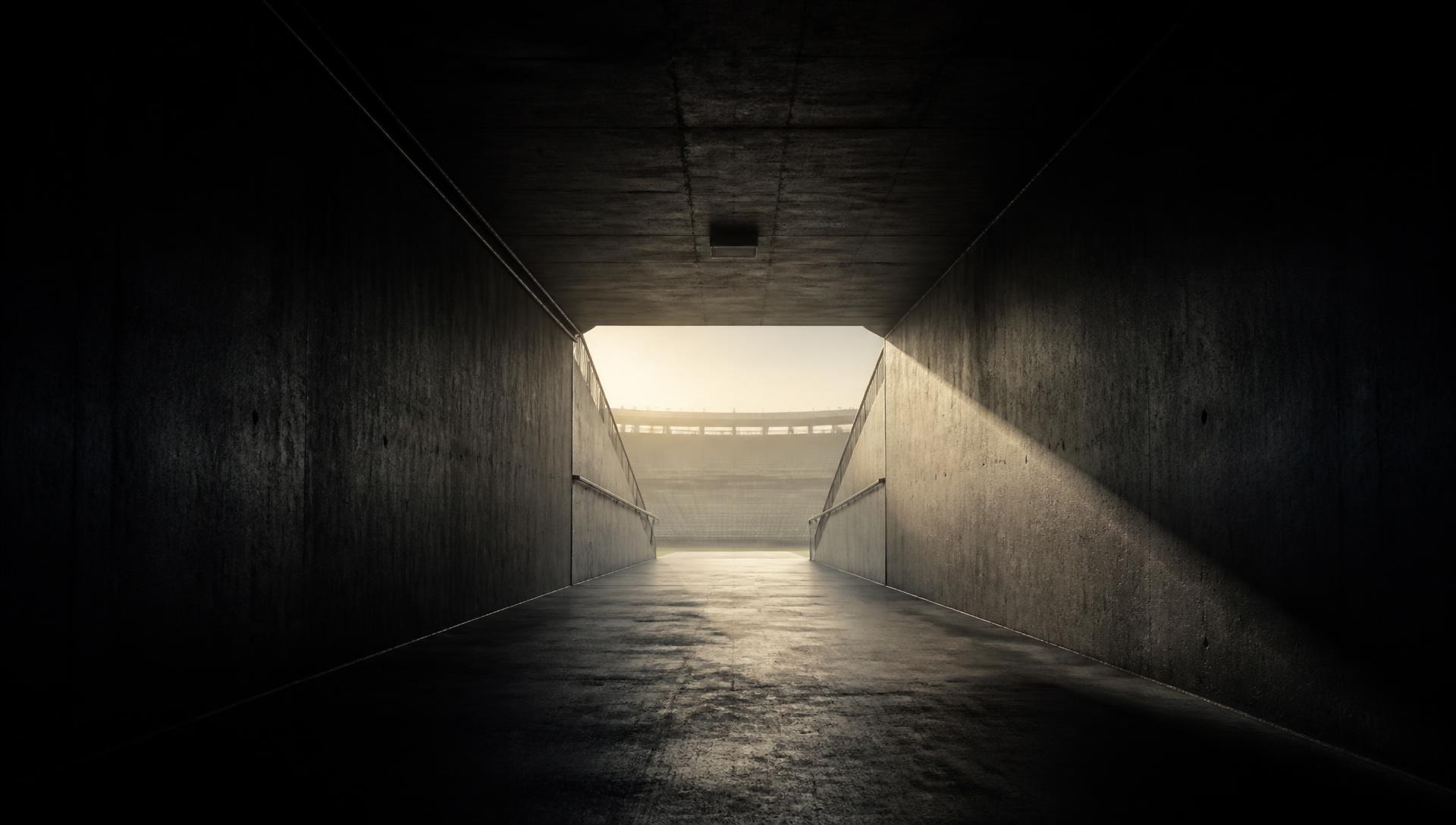 An empty stadium tunnel at dawn.
